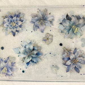 Resin decorative tray with gold handles and blue shimmering flowers. Add a sophisticated touch to your home decor!